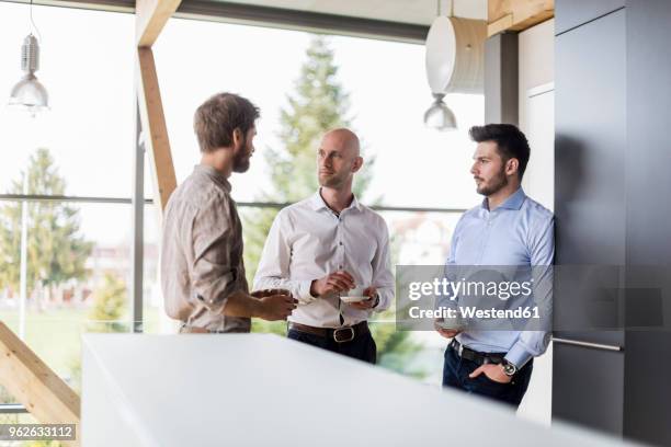 three businessmen talking during coffee break - switzerland business stock pictures, royalty-free photos & images