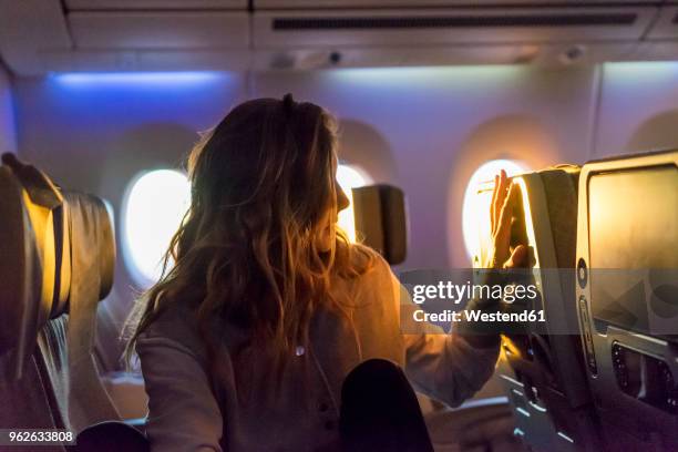young woman in plane at sunrise - twilight stock pictures, royalty-free photos & images