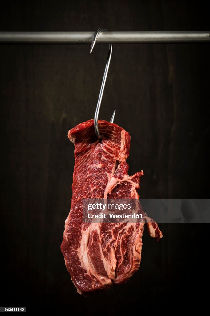 Raw american chuck eye steak on hook