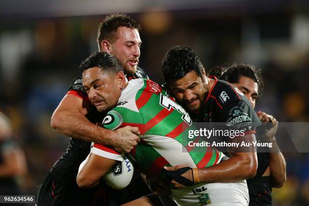 John Sutton of the Rabbitohs on the charge against Karl Lawton and Peta Hiku of the Warriors during the round 12 NRL match between the New Zealand...