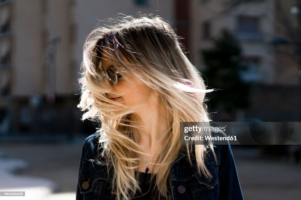 Young woman tossing her hair