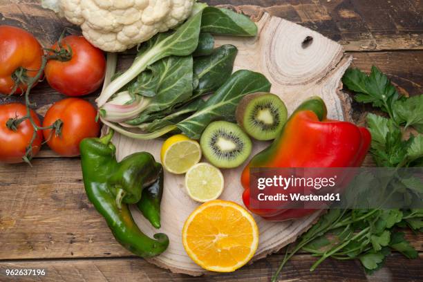 various fruits and vegetables with vitamin c on wood - vitamin c stock-fotos und bilder