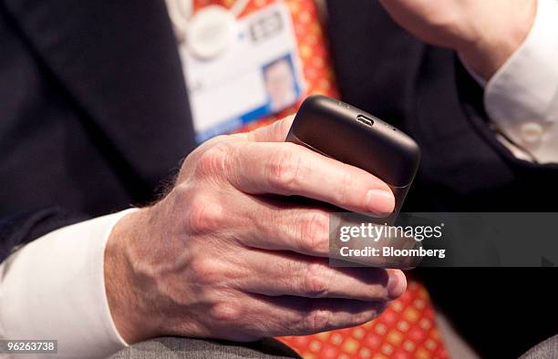 Eric Schmidt, chairman and chief executive officer of Google Inc., holds a Google Nexus One phone during a plenary session titled "Business...