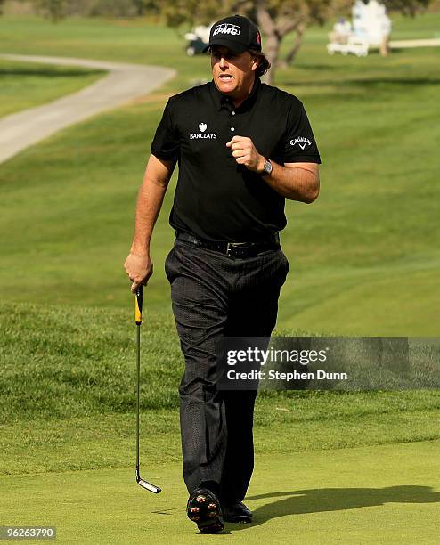 Phil Mickelson pumps his fist after making a birdie putt on the 14th hole at the North Course at Torrey Pines Golf Course during the second round of...