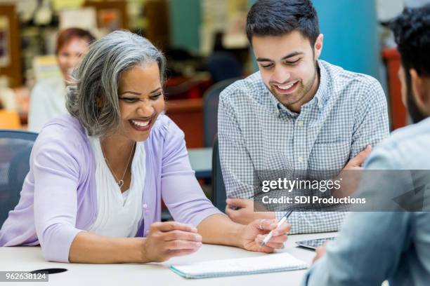 senior woman studies with university classmates - lecturer stock pictures, royalty-free photos & images