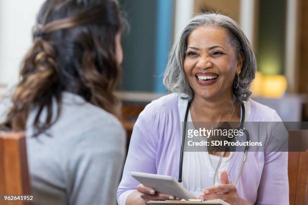 senior african american female medical school professor with student - patient education stock pictures, royalty-free photos & images