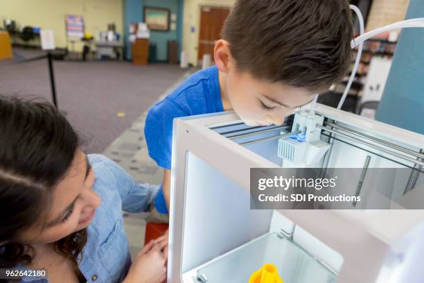 curious little boy watches 3d printer - 3d mom son stock pictures, royalty-free photos & images