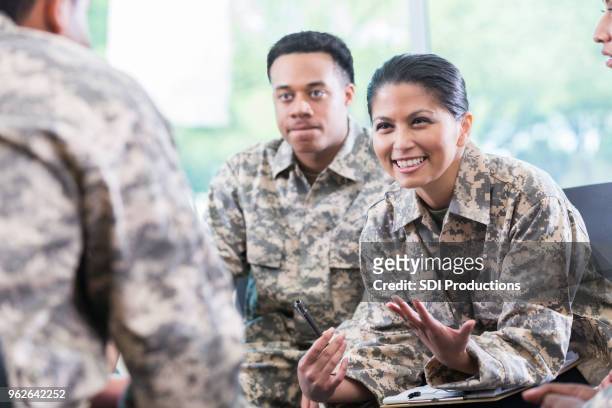 female soldier talks during support group meeting - military uniform stock pictures, royalty-free photos & images