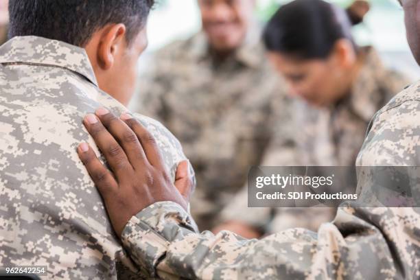 soldaten bidden tijdens therapie sessie - iemand een plezier doen stockfoto's en -beelden