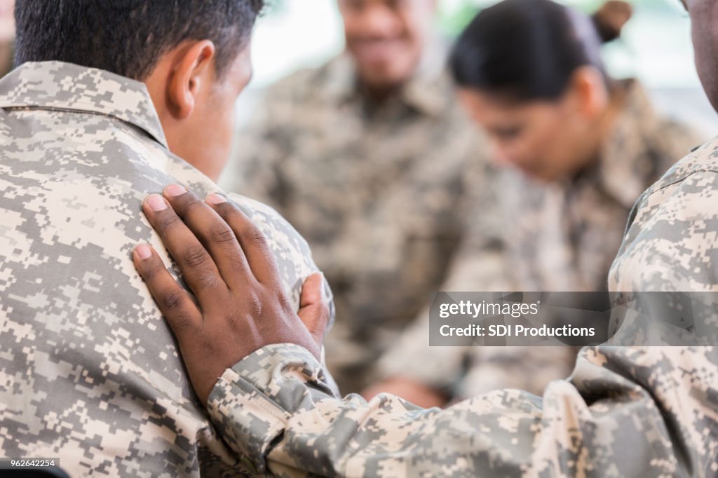 Soldiers pray during therapy session