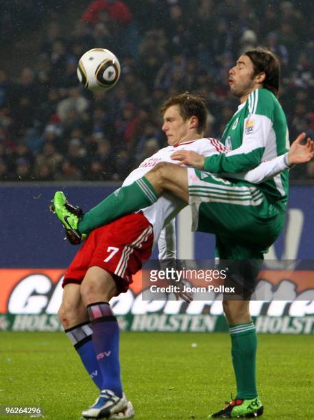 Marcell Jansen of Hamburg and Andrea Barzagli of Wolfsburg battle for the ball during the Bundesliga match between Hamburger SV and VfL Wolfsburg at...
