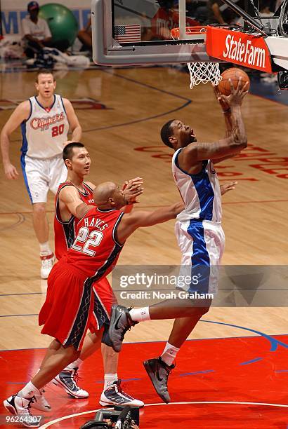 DeAndre Jordan of the Los Angeles Clippers looks to score against Yi Jianlian and Jarvis Hayes of the New Jersey Nets during the game at Staples...