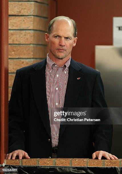 Head coach Ken Whisenhunt of the Arizona Cardinals attends a press conference for quarterback Kurt Warner, as he announces his retirement from...