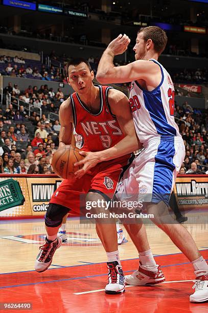 Yi Jianlian of the New Jersey Nets moves the ball against Steve Novak of the Los Angeles Clippers during the game at Staples Center on January 18,...