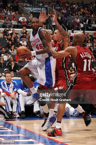 Rasual Butler of the Los Angeles Clippers looks to pass against Michael Beasley and Rafer Alston of the Miami Heat during the game on January 10,...