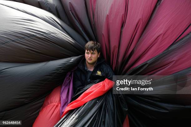 Member of the ground crew gathers up a balloon during the Durham Hot Air Balloon Festival on May 26, 2018 in Durham, England. Held in the city for...