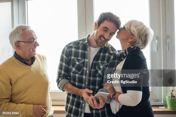 son with his parents - parent stock pictures, royalty-free photos & images