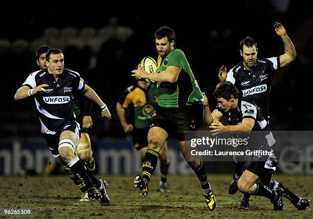 Chris Mayor of Saints is tackled by David Bishop and Charlie Hodgson of Sale during the LV Anglo Welsh Cup match between Sale Sharks and Northampton...