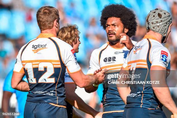 Brumbies' South African center Kyle Godwin celebrates with teammates after scoring a try during the SuperRugby rugby match between the Vodacom Bulls...