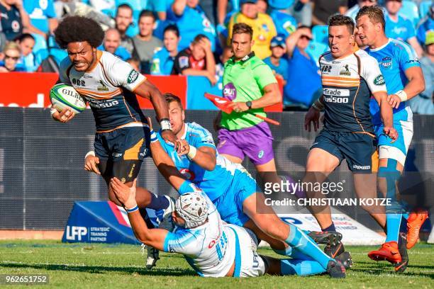 Brumbies's Fidji's winger Henry Speight is tackled by Bulls' South African scrum-half Handre Pollard during the SuperRugby rugby match between the...