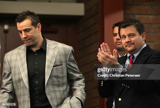 Michael Bidwill, President of the Arizona Cardinals, applauds as quarterback Kurt Warner enters a press conference to announce his retirement from...