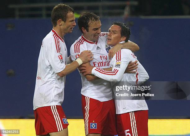 Piotr Trochowski of Hamburg celebrates with his team mates Marcus Berg and Joris Mathijsen after scoring his team's first goal during the Bundesliga...