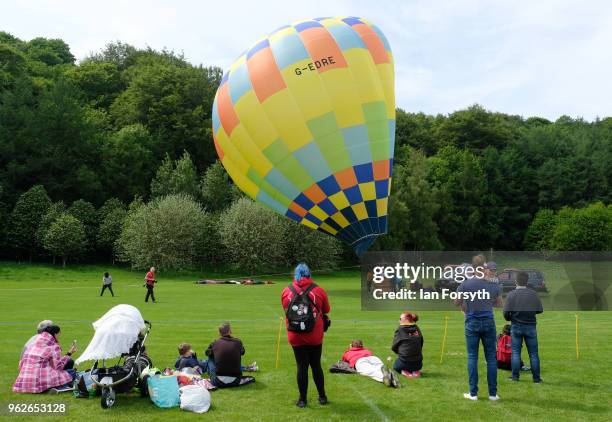 Crowds watch as a tethered hot air balloon is blown by wind during the Durham Hot Air Balloon Festival on May 26, 2018 in Durham, England. Held in...