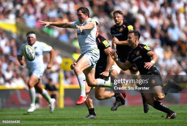 Alex Goode of Saracens protects the ball from Nic White of Exeter Chiefs during the Aviva Premiership Final between Saracens and Exeter Chiefs at...