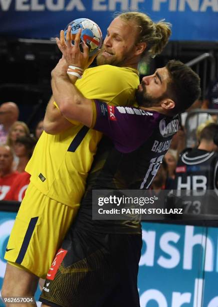 Nantes' David Balaguer Romeu vies with Mikkel Hansen of Paris Saint-Germain's Zarko Sesum during the handball semi-final match HBC Nantes versus...