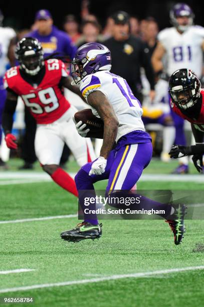 Stefon Diggs of the Minnesota Vikings runs the ball against the Atlanta Falcons at Mercedes-Benz Stadium on December 3, 2017 in Atlanta, Georgia.