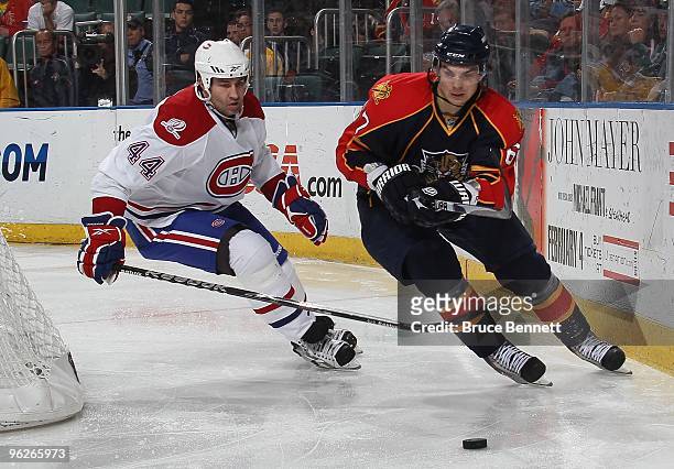 Michael Frolik of the Florida Panthers skates past Roman Hamrlik of the Montreal Canadiens at the BankAtlantic Center on January 26, 2010 in Sunrise,...