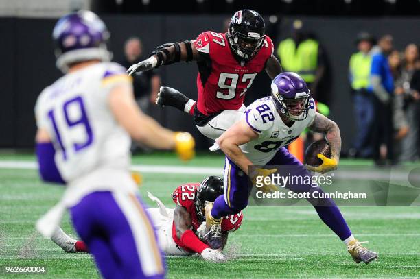 Kyle Rudolph of the Minnesota Vikings runs after a catch against the Atlanta Falcons at Mercedes-Benz Stadium on December 3, 2017 in Atlanta, Georgia.