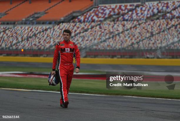 Timmy Hill, driver of the CrashClaimsR.Us Dodge, walks to his car during qualifying for the NASCAR Xfinity Series ALSCO 300 at Charlotte Motor...