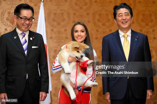 Pyeongchang Olympic Figure Skating Ladies Singles gold medalist Alina Zagitova holds 'Masaru' Akita inu dog presented by Japan on May 26, 2018 in...