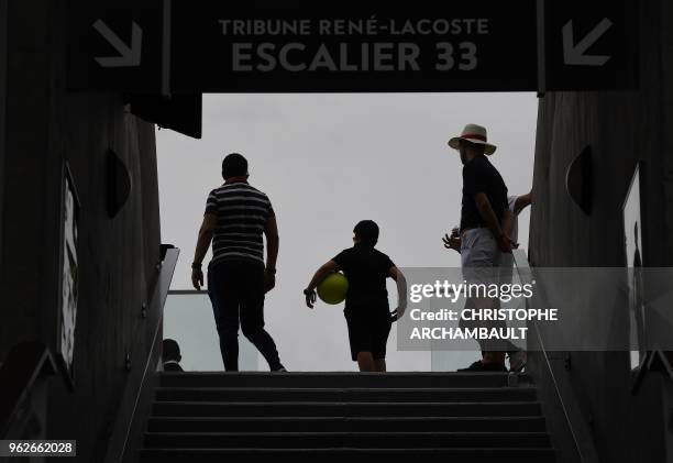 Spectators walk up stairs onto The Philippe Chartier Court during 'Kids Day' at The Roland Garros Complex in Paris on May 26 on the eve of The Roland...