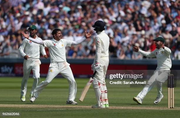 Pakistan bowler Mohammad Abbas runs to celebrate with teammate Shadab Khan after dismissing the England captain Joe Root on day 3 of the First...