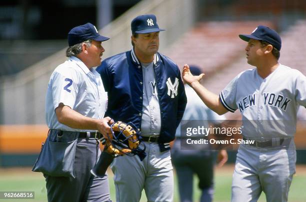 Lou Piniella and Steve Sax of the New York Yankees discuss a call with an umpire in a game against the California Angels at the Big A circa 1988 in...