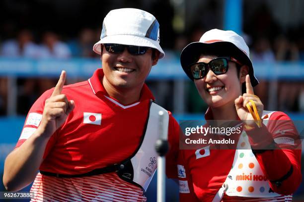 Takaharu Furukawa and Sugimoto Tomomi of Japan celebrate as they take part in the final competition at the second stage of the 2018 Archery World...