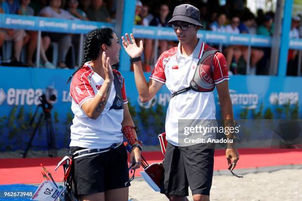 Mete Gazoz and Yasemin Ecem Anagoz of Turkey celebrate as they take part in the final competition at the second stage of the 2018 Archery World Cup,...