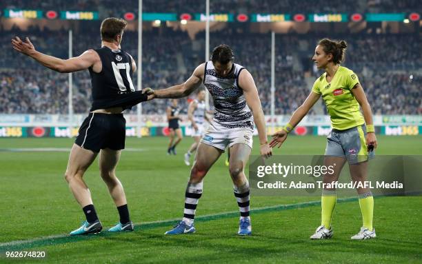 Patrick Dangerfield of the Cats drags Sam Rowe of the Blues back onto the mark during the 2018 AFL round 10 match between the Geelong Cats and the...