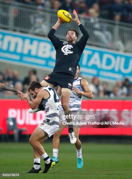 Dale Thomas of the Blues marks the ball over Cory Gregson of the Cats during the 2018 AFL round 10 match between the Geelong Cats and the Carlton...
