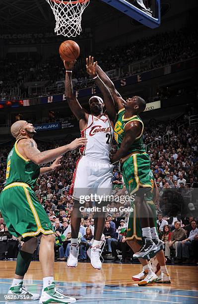 LeBron James of the Cleveland Cavaliers shoots against Ronnie Brewer and Carlos Boozer of the Utah Jazz during the game on January 14, 2010 at...
