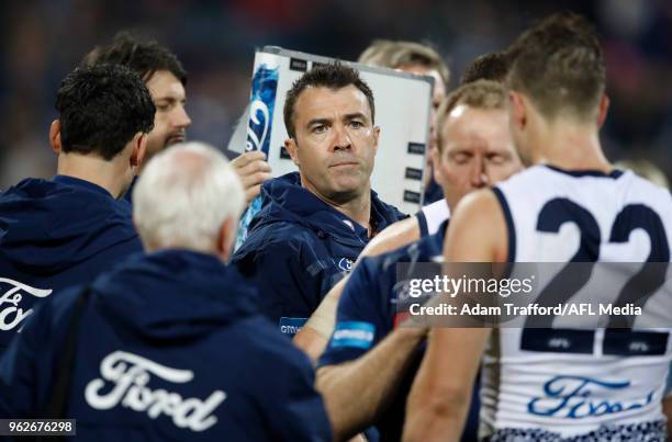 Chris Scott, Senior Coach of the Cats addresses his players during the 2018 AFL round 10 match between the Geelong Cats and the Carlton Blues at...