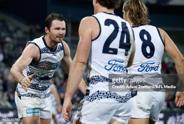 Patrick Dangerfield of the Cats celebrates with Jed Bews and Jake Kolodjashnij of the Cats during the 2018 AFL round 10 match between the Geelong...