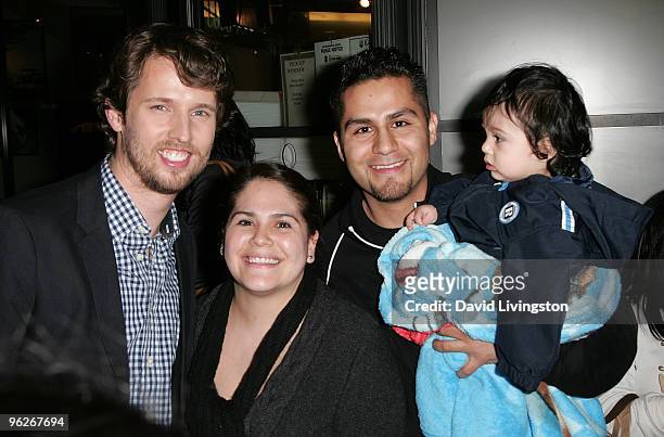 Actor Jon Heder poses with Las Vegas trip winner Paul Montes and his family at ''A Taste of Italy'' at The Grove near the Dancing Fountain on January...