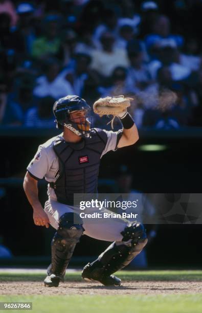 Brad Ausmus of the Houston Astros catches the ball at home plate during their MLB game against the Colorado Rockies on September 10, 1997 at Coors...