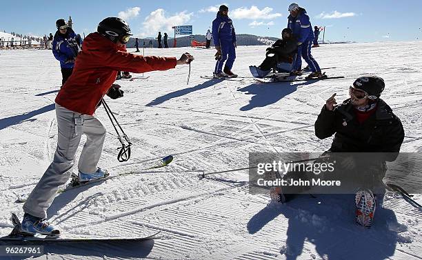 Double-amputee Kevin Pannell gestures as Cheryl Jensen takes a photo on the slopes January 29, 2010 in Vail, Colorado. Pannell, from Portland,...