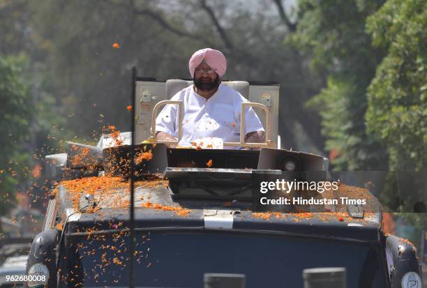 Punjab Chief Minister Capt Amarinder Singh waving to congress supports during road show ahead of Shahkot By poll in Lohain Khas, on May 26, 2018 in...