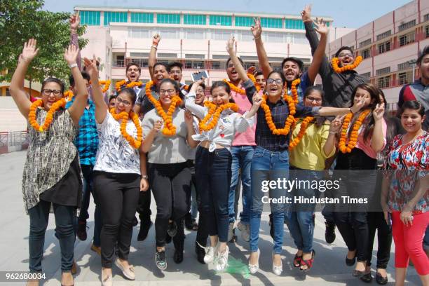 Students celebrate their success after the declaration of Central Board of Secondary Education 's class 12th result, at a DAV International school,...