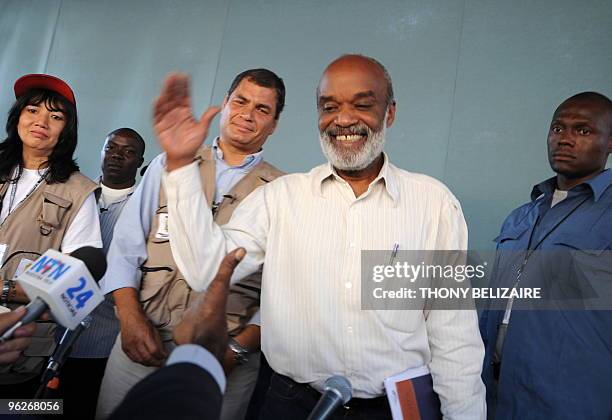 Haitian President Rene Preval shakes hands with a member of the press as Ecuadorian President Rafael Correa leaves a joint press conference on...